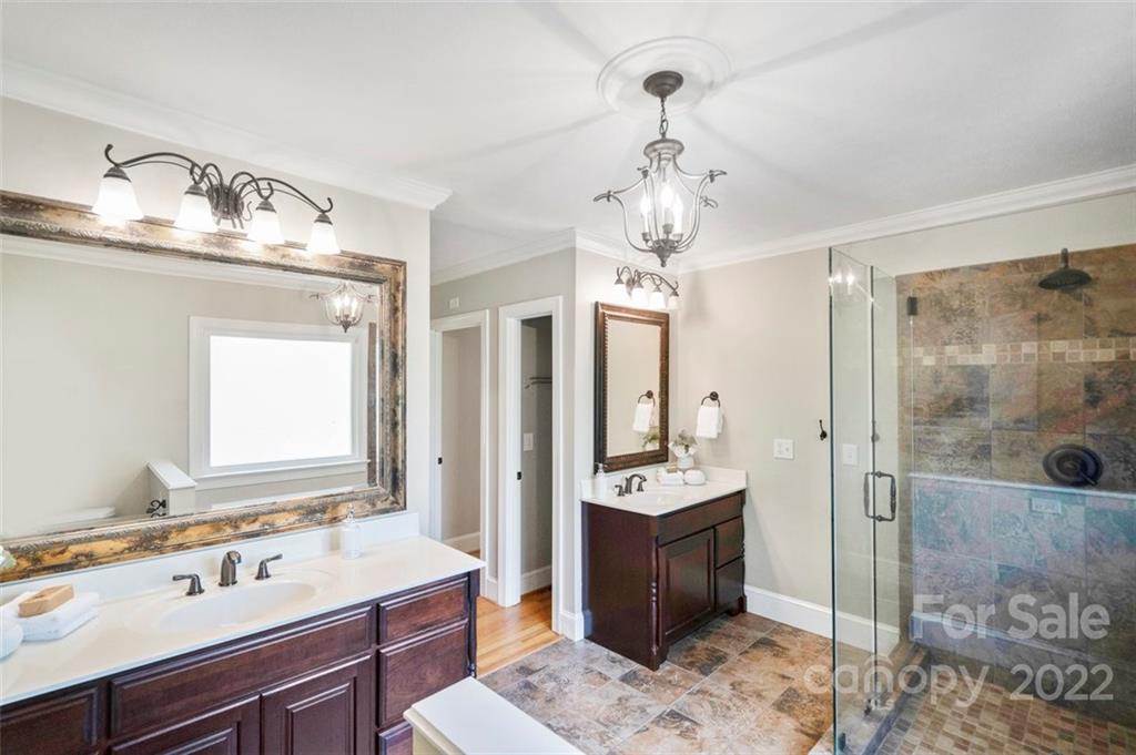 1435 Lilac Road Charlotte, NC 28209 - Photo 20 of 33 a spacious bathroom with a sink a mirror and shower