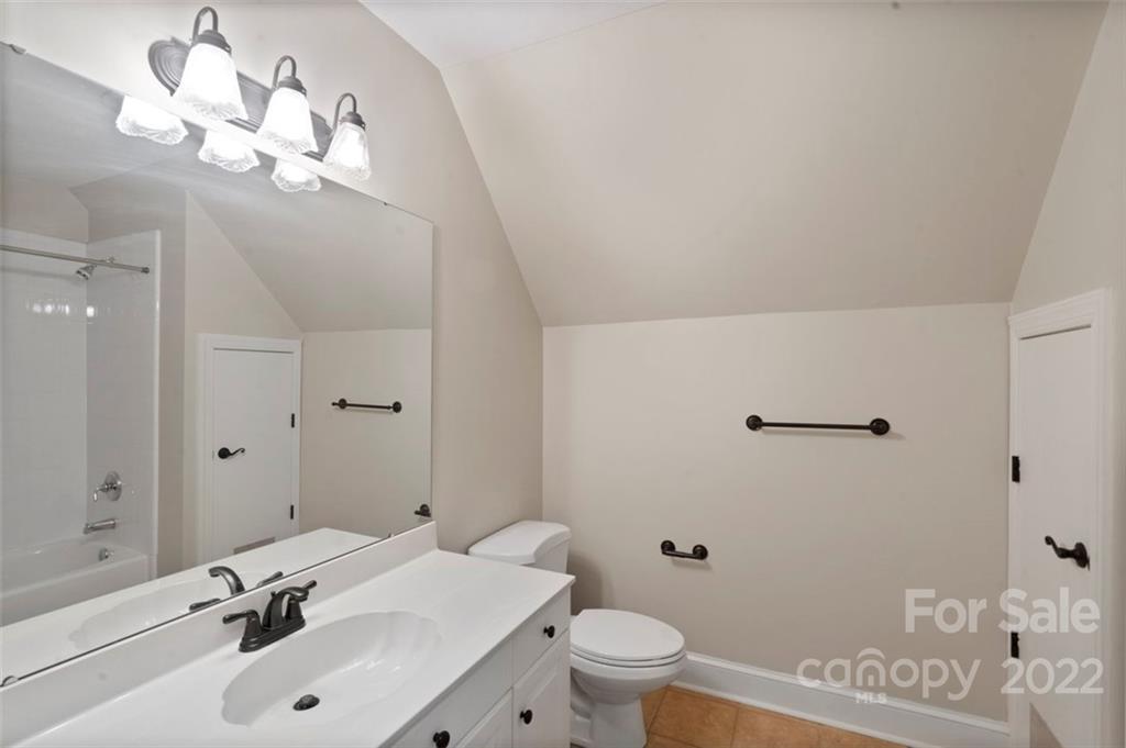 1435 Lilac Road Charlotte, NC 28209 - Photo 26 of 33 a bathroom with a sink a toilet and a mirror