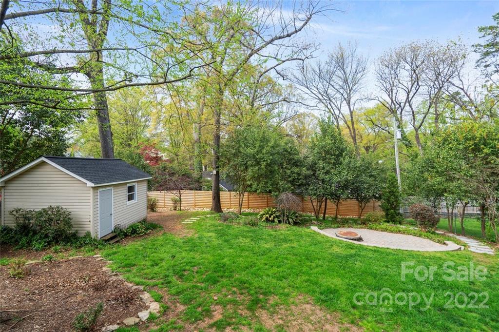 1435 Lilac Road Charlotte, NC 28209 - Photo 31 of 33 a view of a house with a backyard and a tree