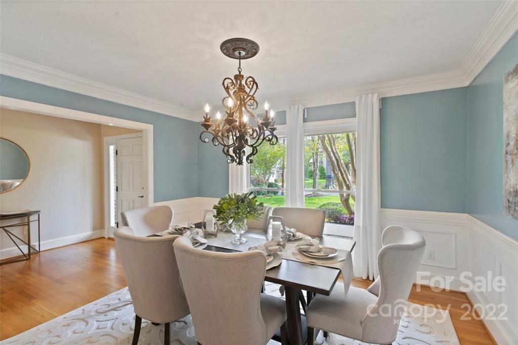 1435 Lilac Road Charlotte, NC 28209 - Photo 4 of 33 a dining room with furniture a chandelier and wooden floor