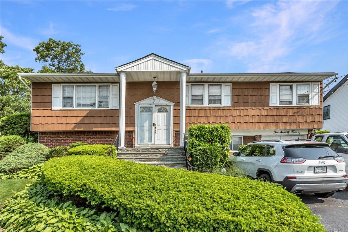 a front view of a house with garden
