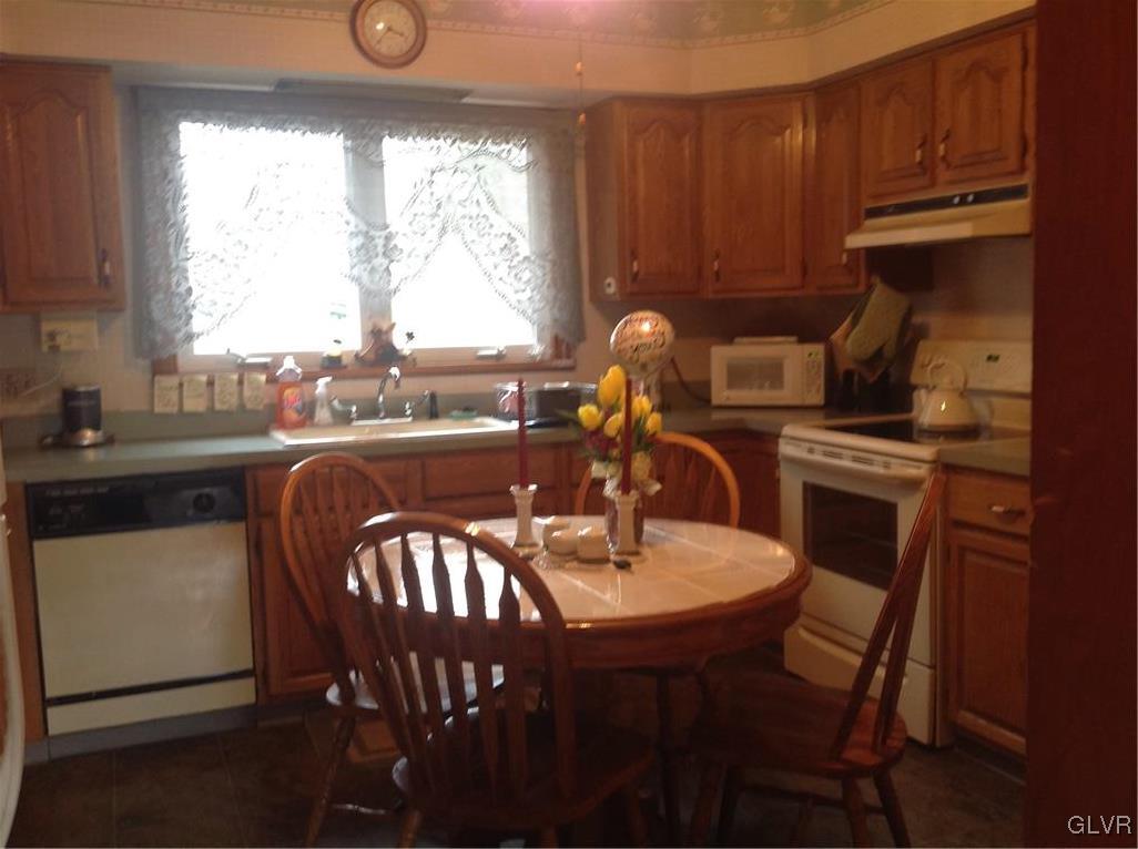 56 Ridgewood Road Easton, PA 18045 - Photo 17 of 19 a kitchen with a table chairs sink and cabinets