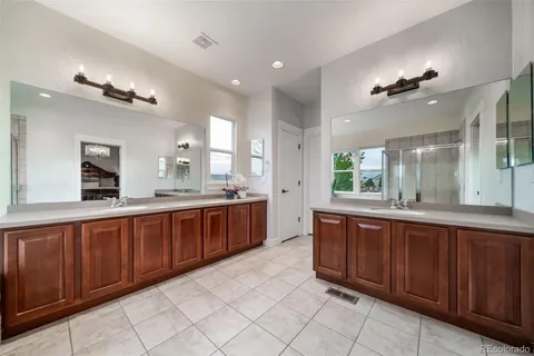a spacious bathroom with a tub sink and mirror