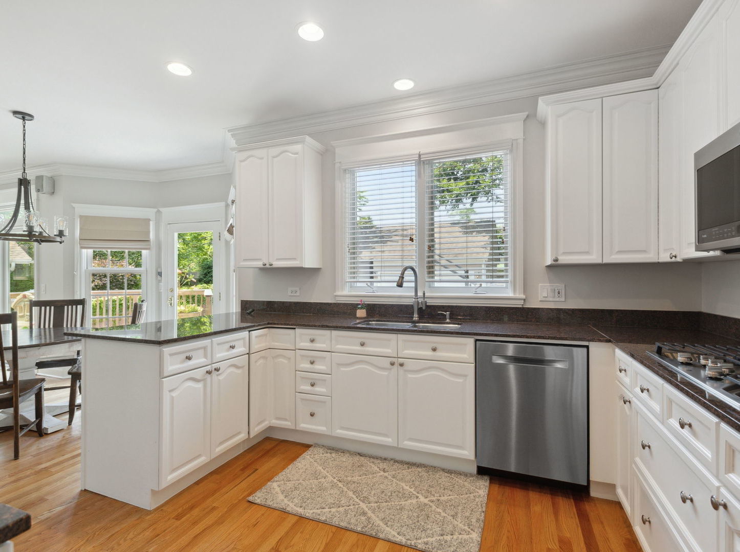 1170 Griffith Road Lake Forest, IL 60045 - Photo 11 of 34 a kitchen with granite countertop white cabinets sink and window