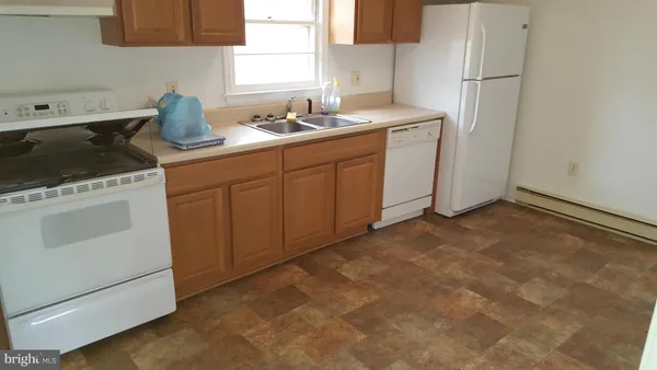 a kitchen with a sink cabinets and appliances