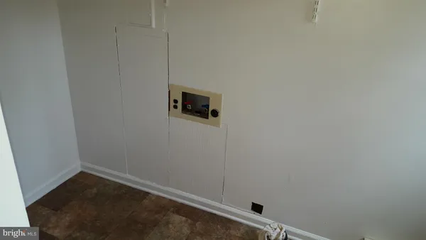 a room with a wooden floor and white walls