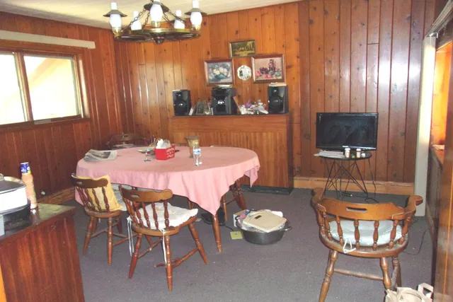 a dining room with furniture and window