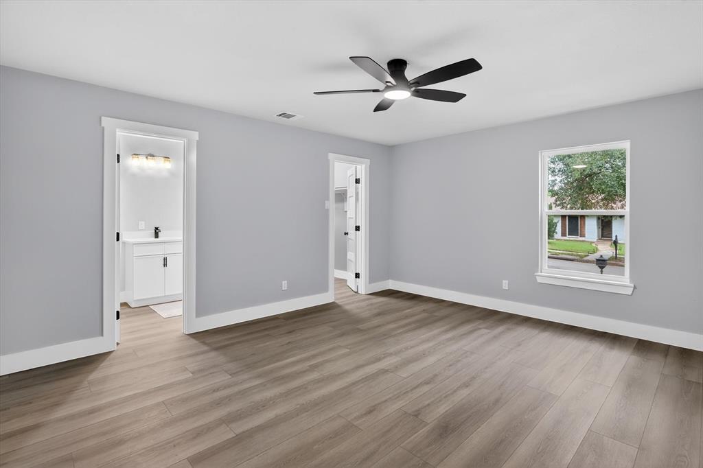 2005 Chestnut Road Carrollton, TX 75007 - Photo 25 of 35 a view of an empty room with wooden floor and a window
