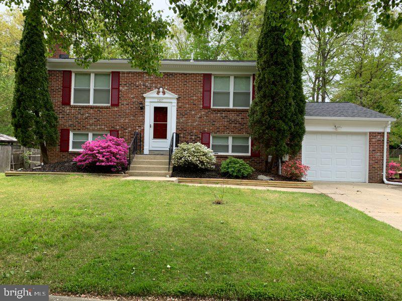 Front of property with azaleas in full bloom.