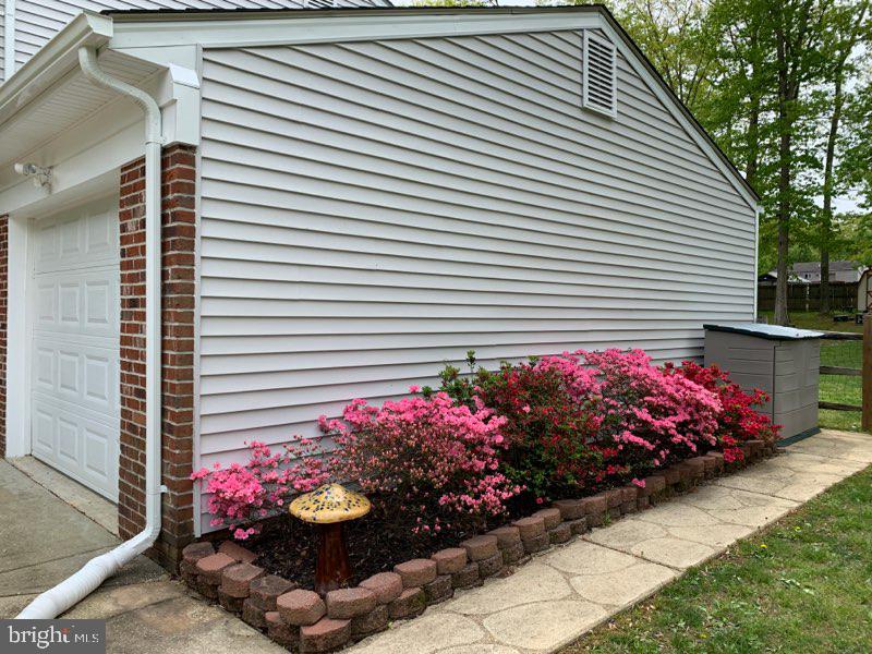 Side of property with azaleas in full bloom