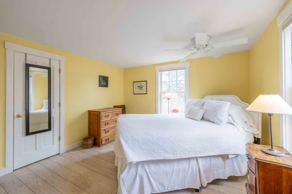 a bedroom with a bed and a lamp