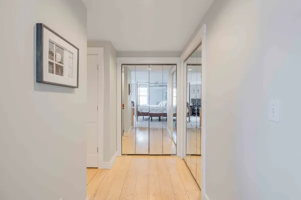 a view of empty room with wooden floor