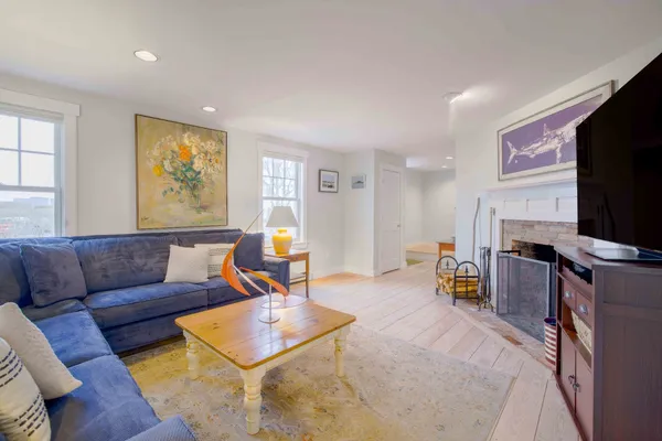 a living room with furniture a fireplace and a flat screen tv