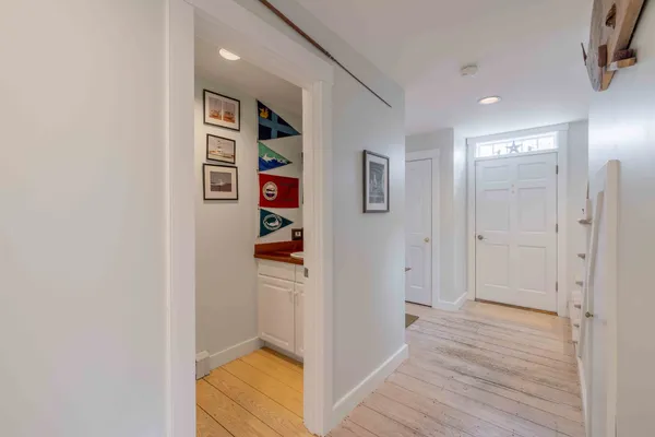 a view of a hallway with wooden floor and closet