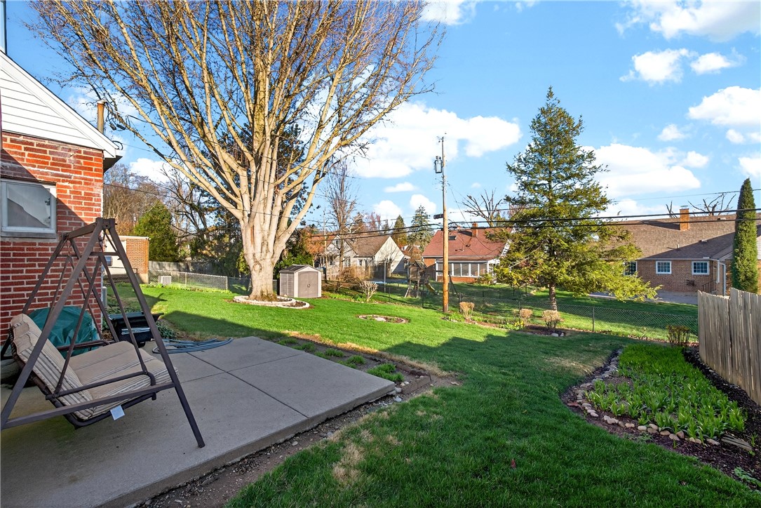 1237 Laurelwood Road Dayton, OH 45409 - Photo 43 of 56 This spacious yard offers a serene retreat with mature trees and ample green space for outdoor enjoyment.