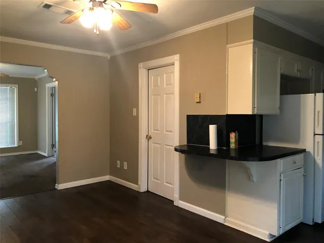 a kitchen with a refrigerator and a microwave