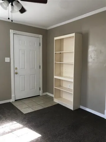 a view of an empty room with a closet