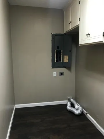a room with a wooden floor and cabinets
