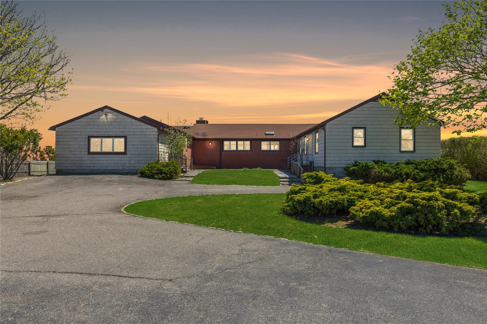 View of front of home featuring asphalt driveway