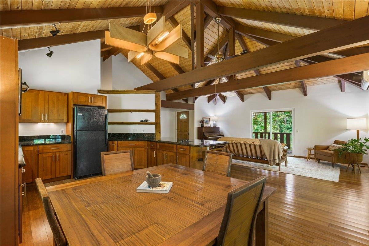 4510 Waha Place, Unit 2 Haiku, HI 96708 - Photo 12 of 36 a kitchen with stainless steel appliances kitchen island granite countertop a table and chairs in it