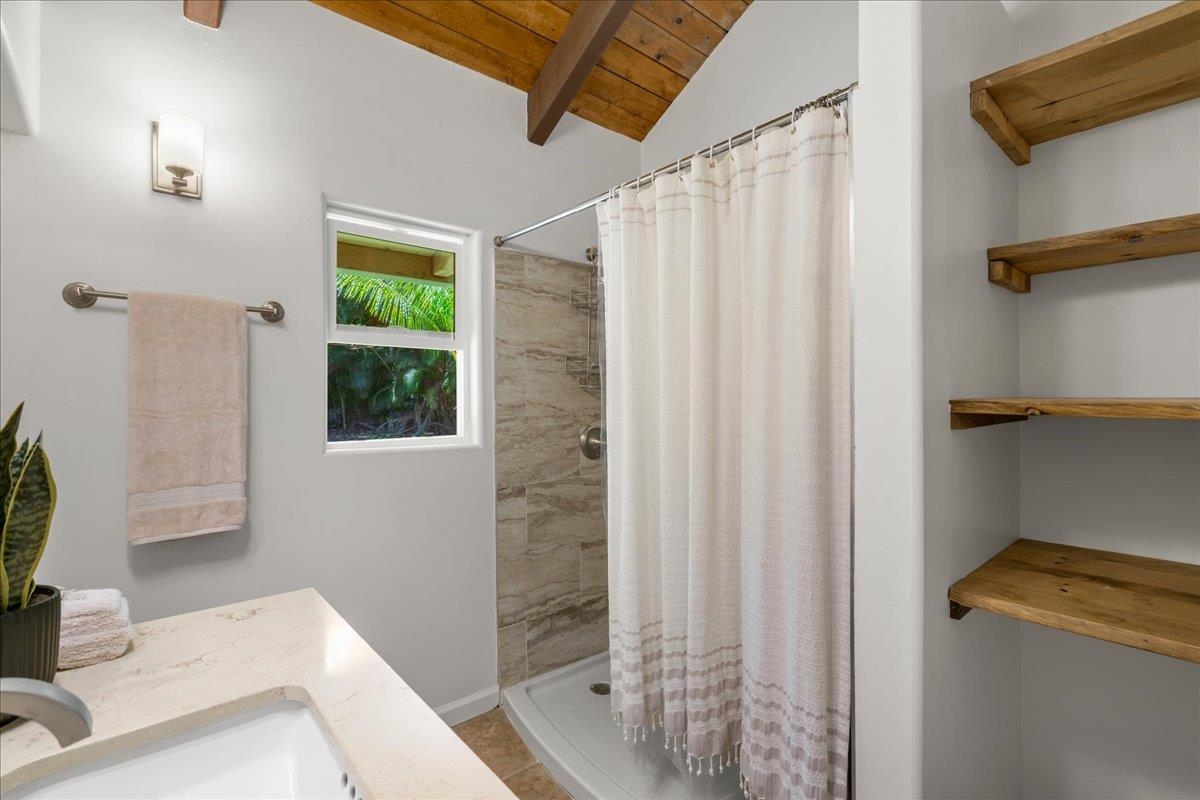 4510 Waha Place, Unit 2 Haiku, HI 96708 - Photo 20 of 36 a bathroom with a shower curtain and a sink