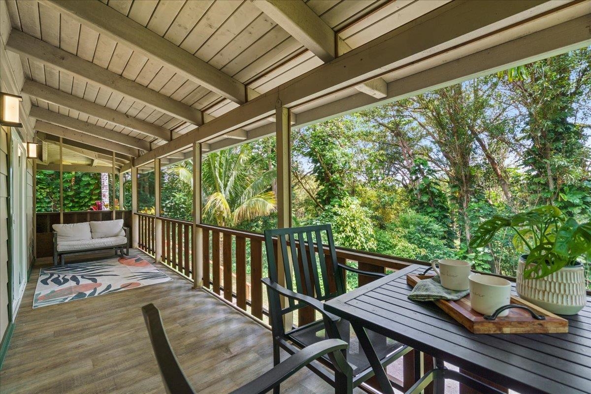 4510 Waha Place, Unit 2 Haiku, HI 96708 - Photo 26 of 36 a view of a balcony with chairs and wooden floor