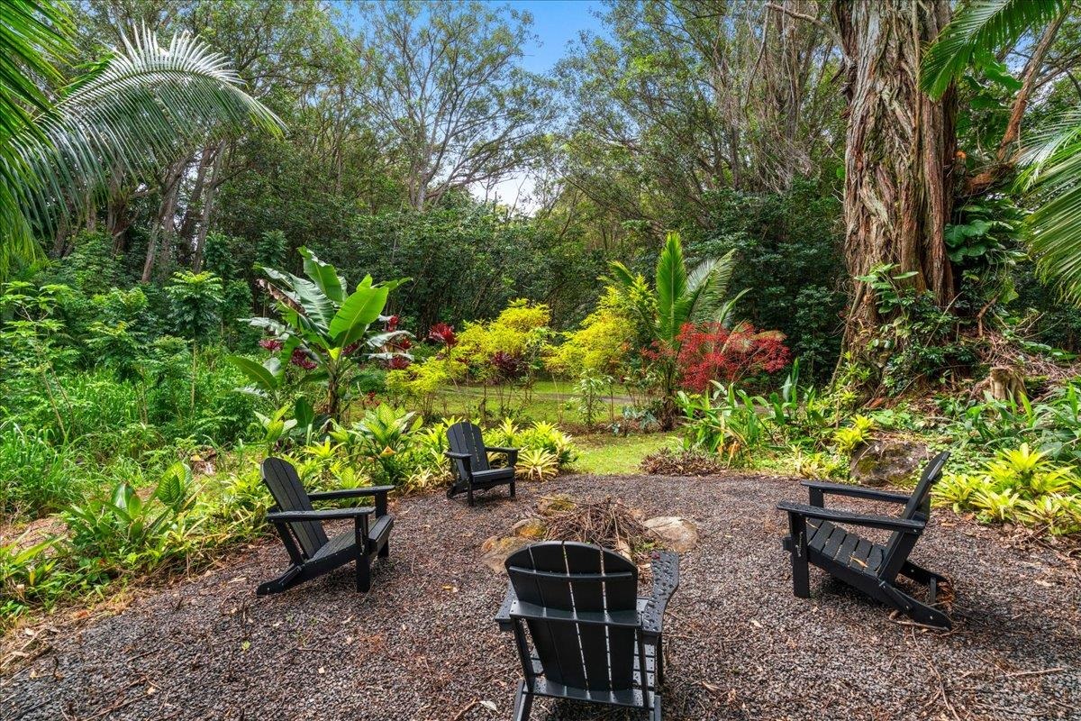 4510 Waha Place, Unit 2 Haiku, HI 96708 - Photo 4 of 36 a garden with a bench and some plants