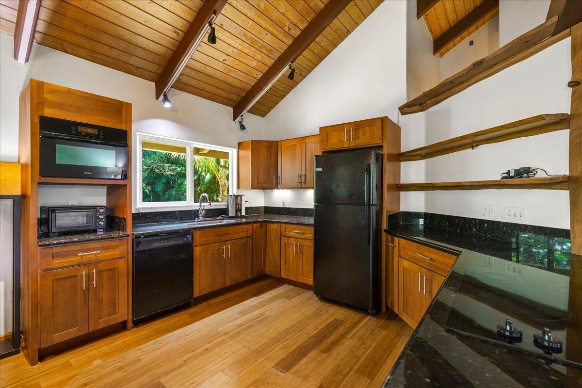 4510 Waha Place, Unit 2 Haiku, HI 96708 - Photo 10 of 36 a kitchen with stainless steel appliances granite countertop a refrigerator a stove and a sink