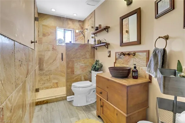 a bathroom with a sink toilet and shower