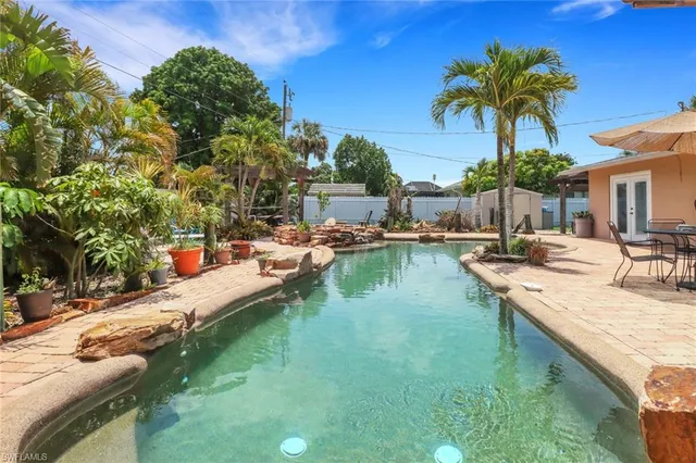 a view of swimming pool with a table and chairs