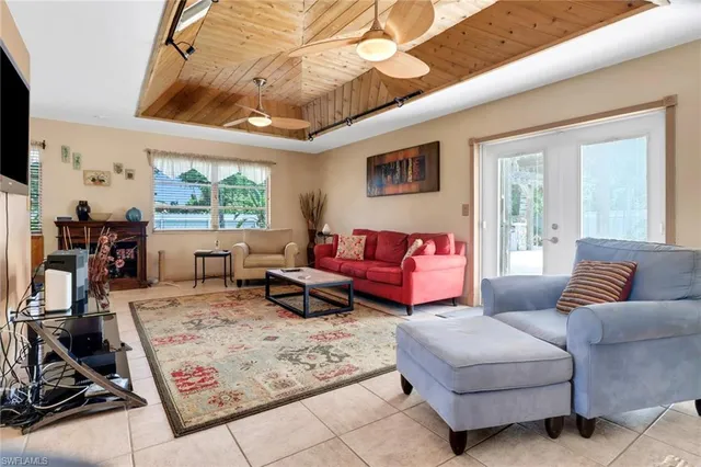 a living room with furniture a flat screen tv and a large window