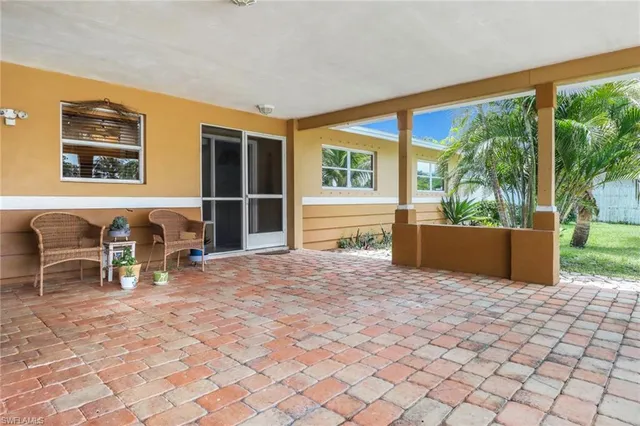 a view of a chairs and table in the patio