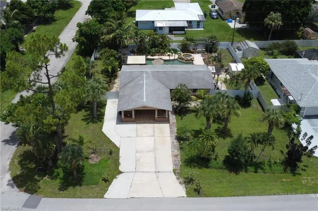 an aerial view of a house with yard and green space