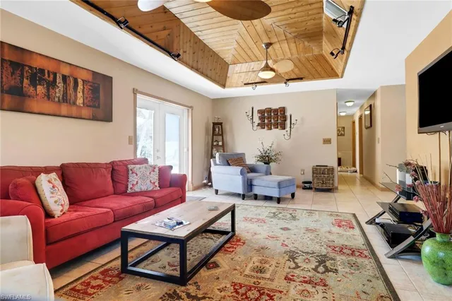 a living room with furniture a flat screen tv and a rug