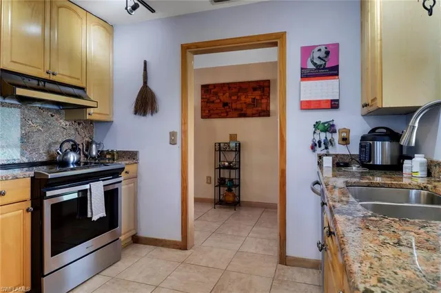 a kitchen with stainless steel appliances granite countertop a stove and a sink