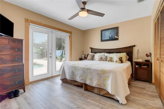 a bedroom with a large bed and a chandelier
