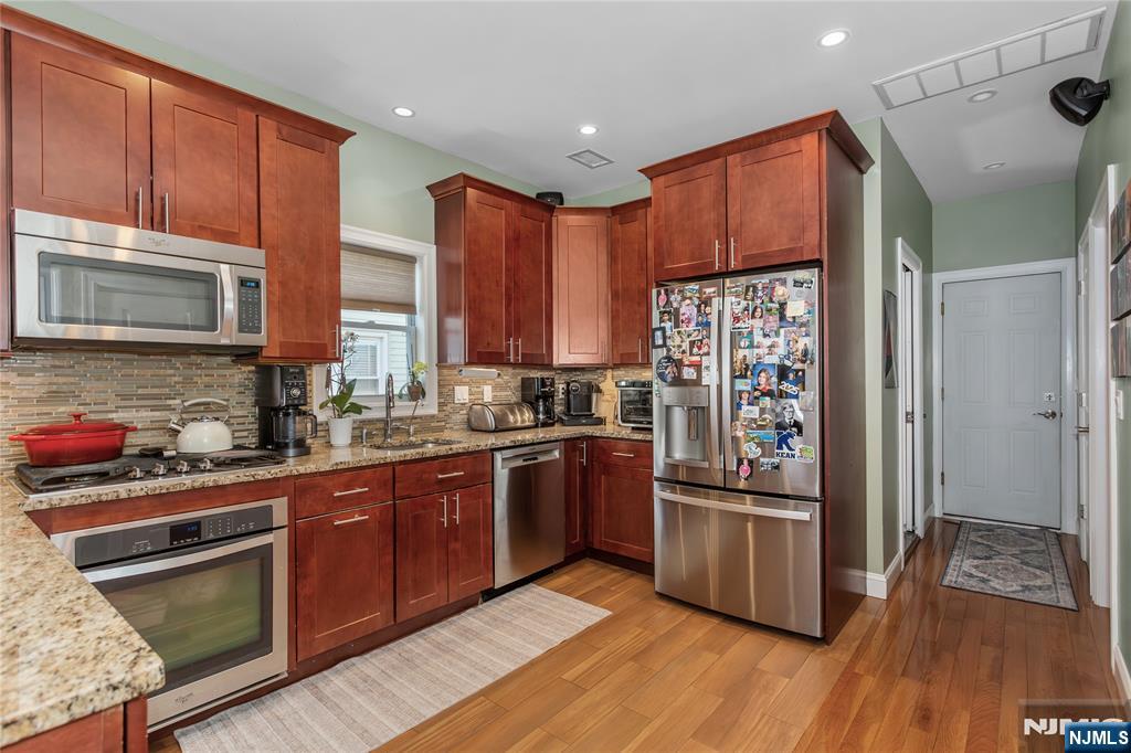 204 Hayward Place Wallington, NJ 07057 - Photo 18 of 39 a kitchen with stainless steel appliances granite countertop a refrigerator stove and sink