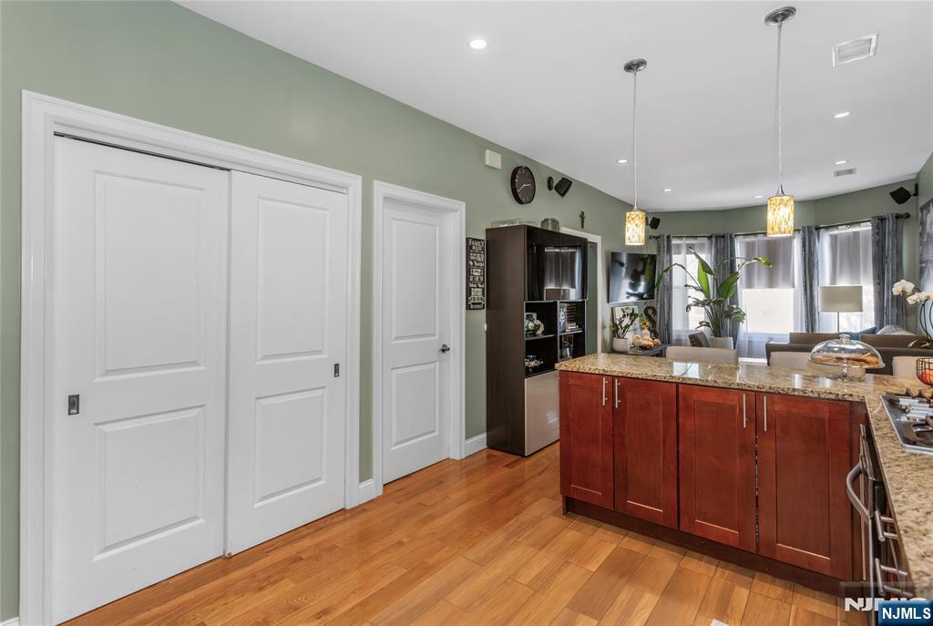 204 Hayward Place Wallington, NJ 07057 - Photo 20 of 39 a view of a kitchen with kitchen island granite countertop wooden floors and stainless steel appliances