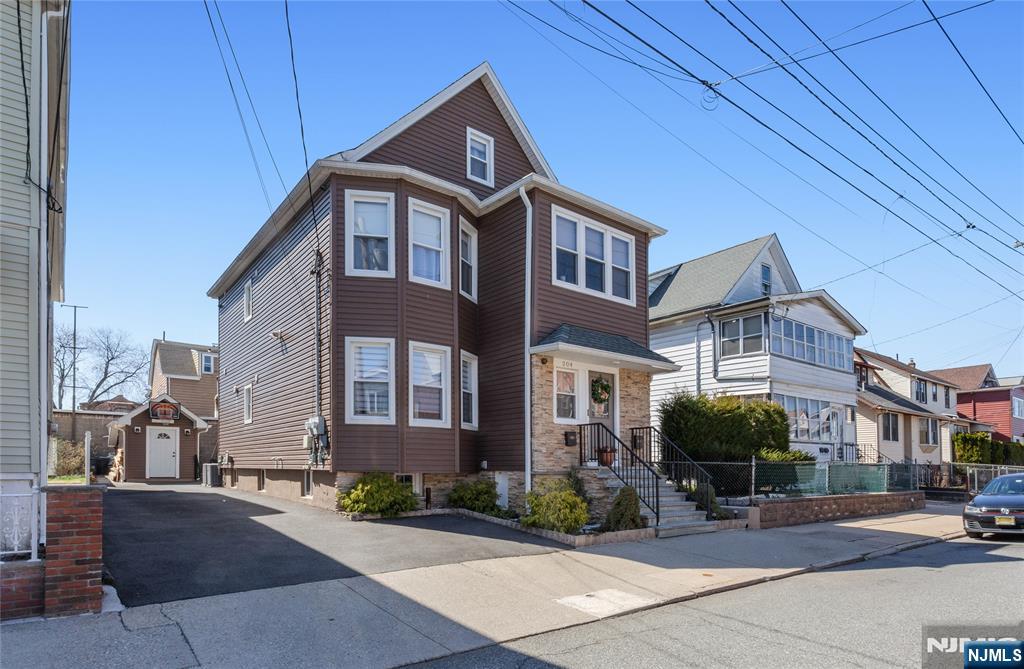 204 Hayward Place Wallington, NJ 07057 - Photo 2 of 39 a front view of a building with sitting area