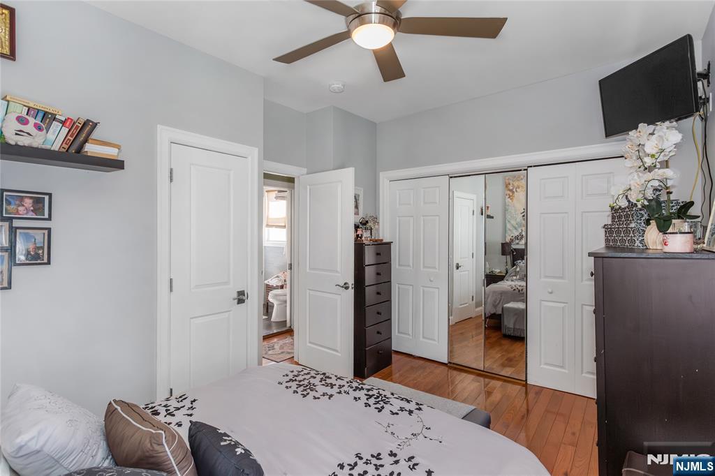 204 Hayward Place Wallington, NJ 07057 - Photo 22 of 39 a bedroom with a bed and a flat screen tv