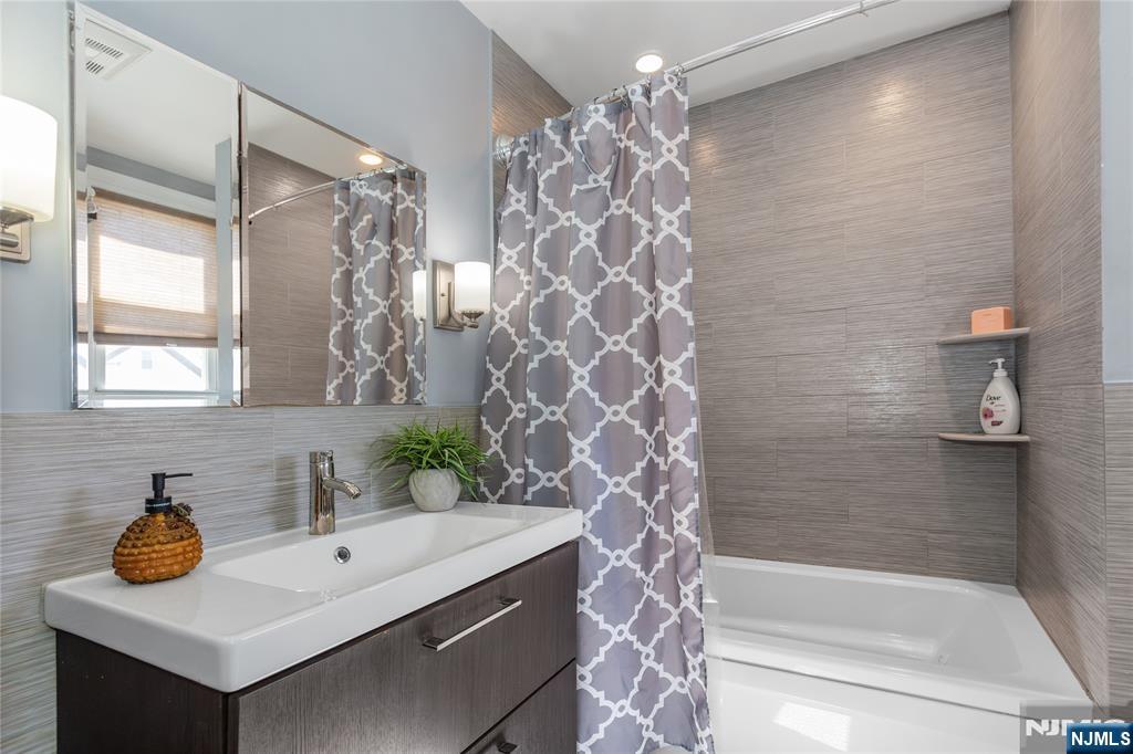 204 Hayward Place Wallington, NJ 07057 - Photo 25 of 39 a bathroom with a sink a toilet and shower