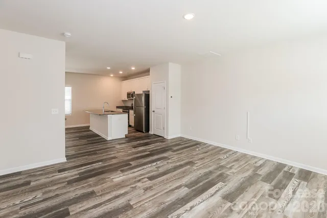 a view of a room with wooden floor