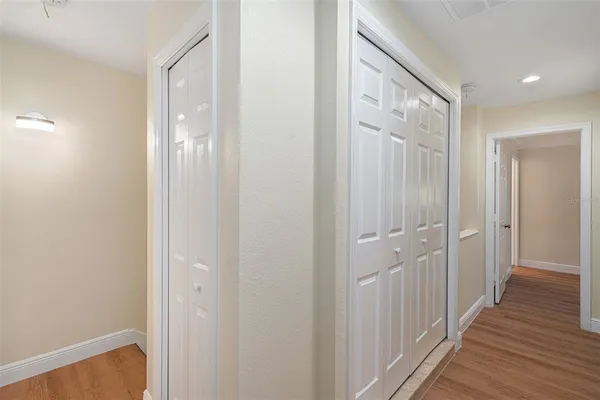 a view of a hallway with wooden floor