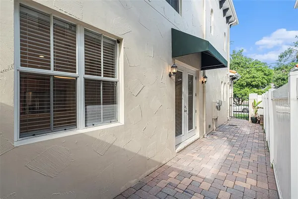 a view of house with backyard porch and garden