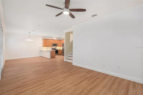 a view of empty room with wooden floor and window