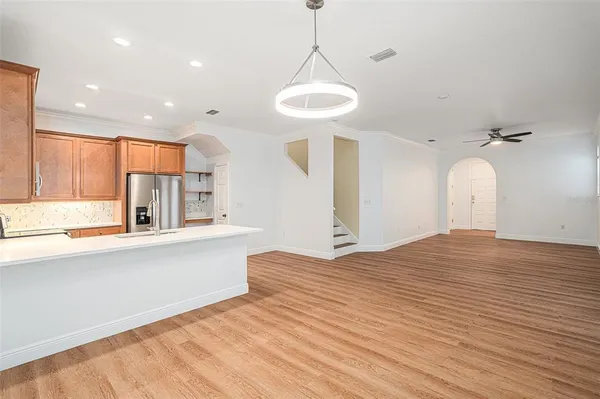 a view of a kitchen with a sink and wooden floor