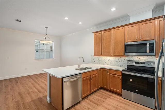 a kitchen with a sink stove and microwave