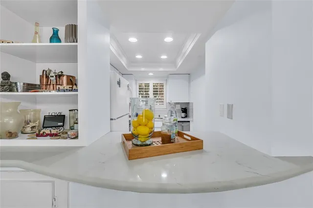 a bedroom with furniture and a large window
