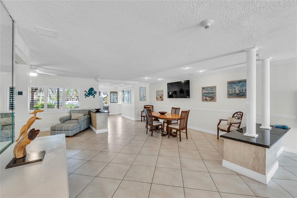1198 Hillsboro Mile, Unit 212 Hillsboro Beach, FL 33062 - Photo 17 of 64 a living room with furniture and a flat screen tv