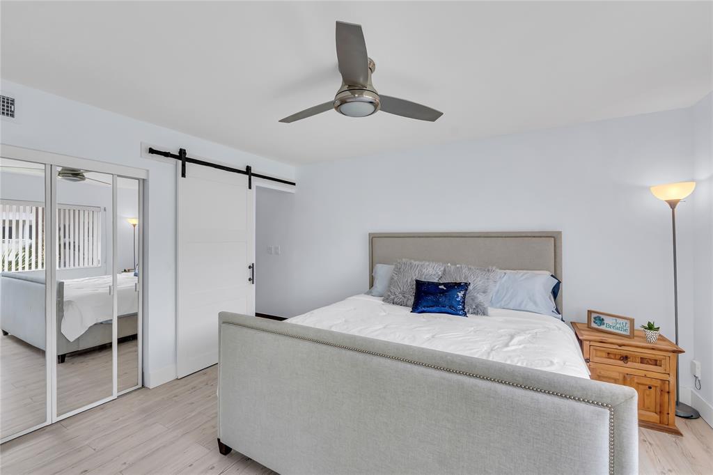 1198 Hillsboro Mile, Unit 212 Hillsboro Beach, FL 33062 - Photo 20 of 64 a bedroom with a bed and a chair